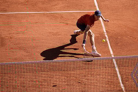 Jannik Sinner plays a shot against Carlos Alcaraz